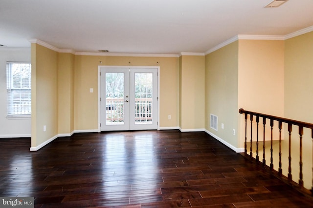 empty room featuring french doors, dark hardwood / wood-style floors, and ornamental molding