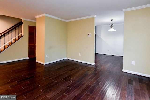 empty room with crown molding and dark hardwood / wood-style floors