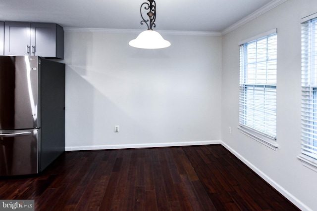 unfurnished dining area featuring dark hardwood / wood-style flooring and crown molding