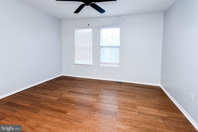 unfurnished room featuring ceiling fan and dark hardwood / wood-style floors