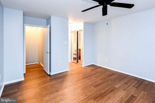 unfurnished bedroom featuring hardwood / wood-style flooring, ceiling fan, and a closet