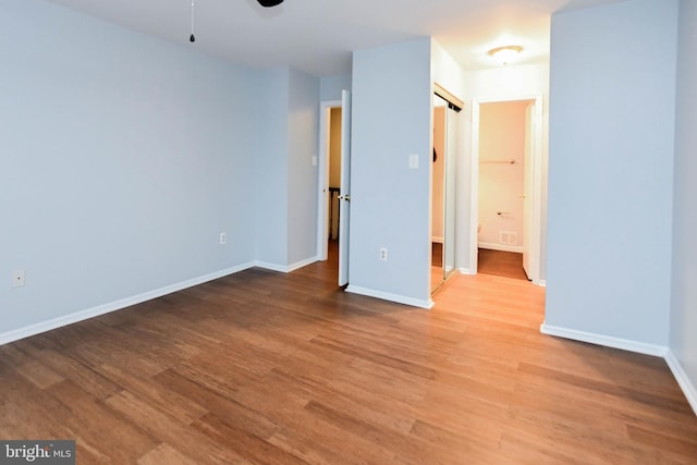 empty room featuring hardwood / wood-style flooring and ceiling fan