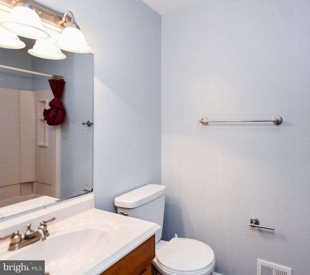 bathroom featuring vanity and toilet