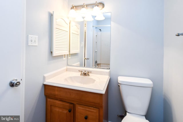 bathroom with vanity, toilet, and walk in shower