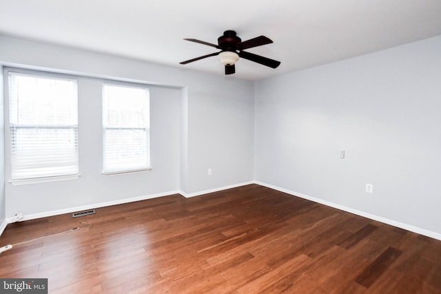 spare room with hardwood / wood-style floors and ceiling fan