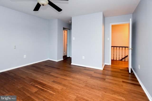 unfurnished room featuring ceiling fan and dark wood-type flooring