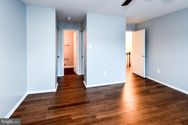 unfurnished room featuring ceiling fan and dark hardwood / wood-style flooring