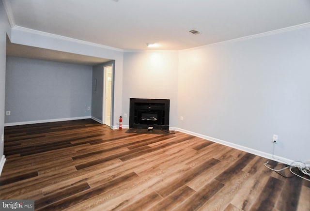 basement with ornamental molding and dark wood-type flooring