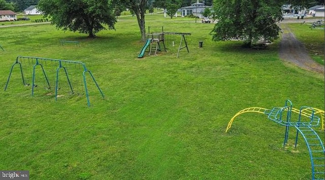 view of home's community featuring a playground and a lawn