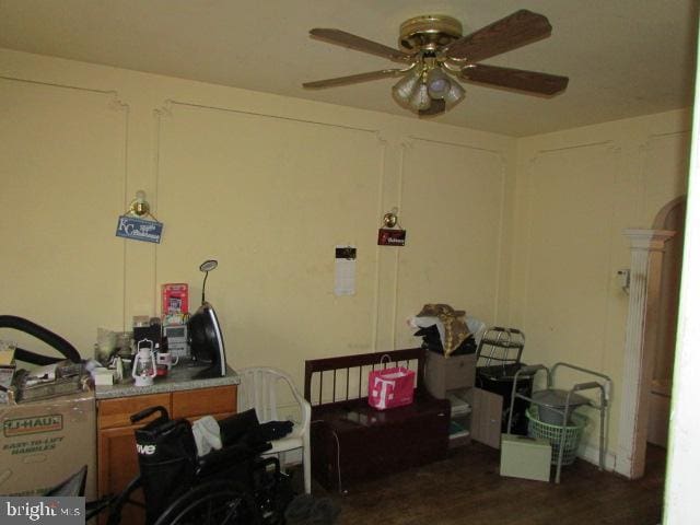 miscellaneous room featuring ceiling fan and dark wood-type flooring