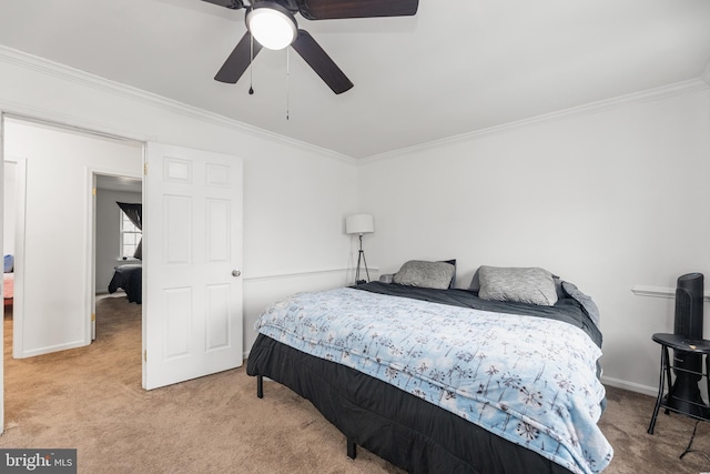 carpeted bedroom with ceiling fan and crown molding