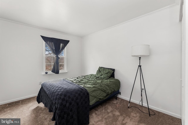 bedroom featuring dark carpet and ornamental molding