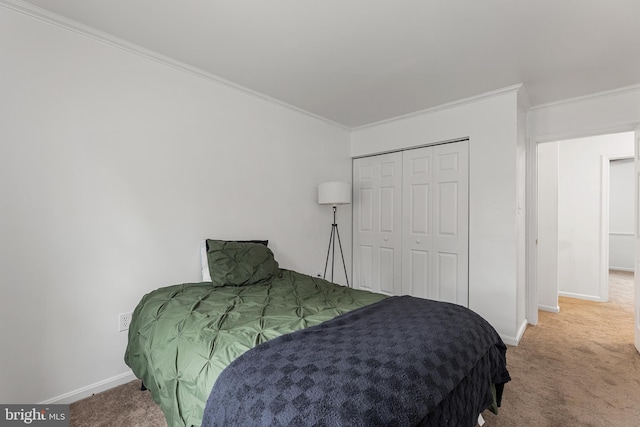 carpeted bedroom featuring a closet and crown molding