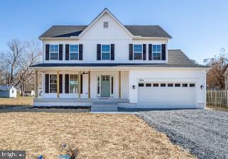 view of front of property featuring a porch and a garage