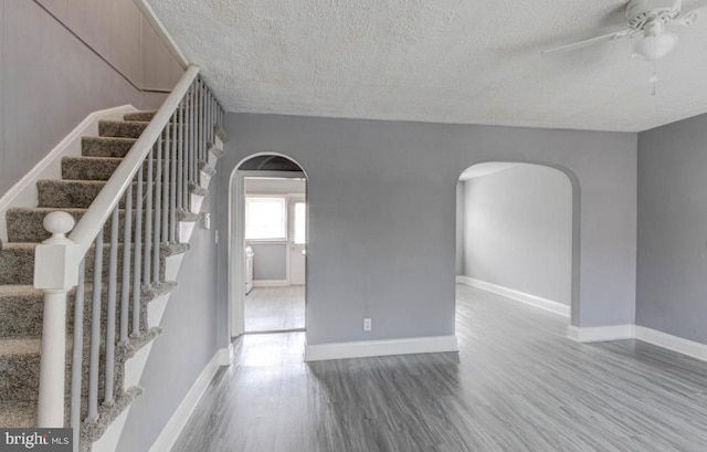 interior space featuring ceiling fan, hardwood / wood-style floors, and a textured ceiling