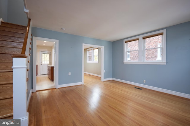526 Powhatan Pl NW, Washington, DC 20011 - spare room featuring light wood finished floors, baseboards, stairway, and a smoke detector