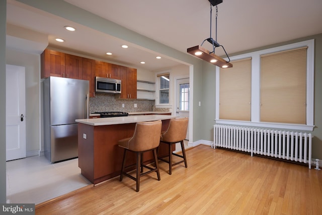 526 Powhatan Pl NW, Washington, DC 20011 - kitchen featuring radiator, stainless steel appliances, light countertops, open shelves, and recessed lighting
