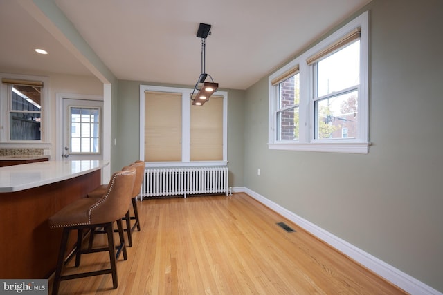526 Powhatan Pl NW, Washington, DC 20011 - dining space featuring radiator, light wood finished floors, healthy amount of natural light, and baseboards