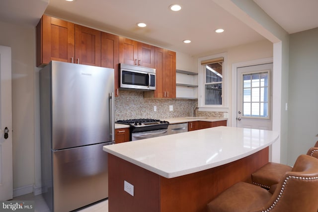 kitchen featuring backsplash, stainless steel appliances, a kitchen island, and sink