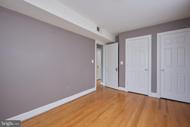 unfurnished bedroom featuring light wood-type flooring