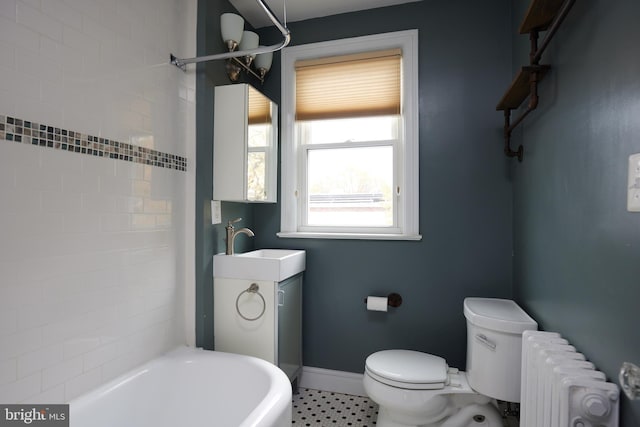 bathroom with toilet, radiator heating unit, and sink