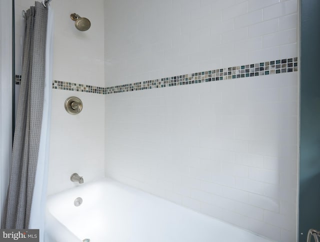 bathroom with shower / bathtub combination with curtain