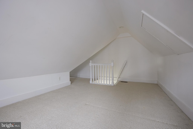 bonus room featuring light colored carpet and vaulted ceiling