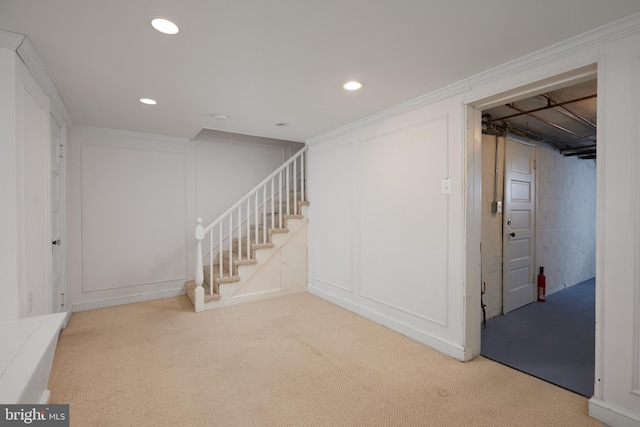 basement with carpet floors and ornamental molding