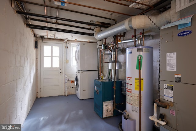 utility room featuring heating unit, stacked washer / dryer, and water heater