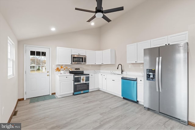 kitchen with appliances with stainless steel finishes, ceiling fan, sink, light hardwood / wood-style flooring, and white cabinets