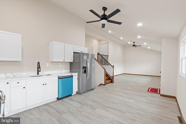 kitchen with ceiling fan, sink, stainless steel appliances, white cabinets, and light wood-type flooring