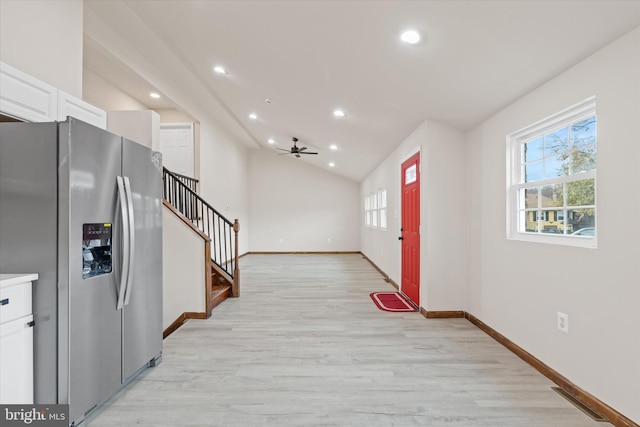 entrance foyer featuring light wood-type flooring, vaulted ceiling, and ceiling fan