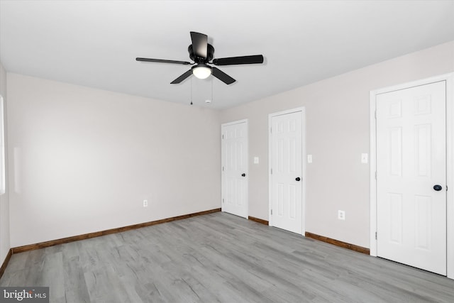 unfurnished bedroom with ceiling fan and light hardwood / wood-style floors