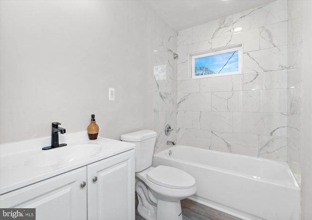 full bathroom featuring vanity, hardwood / wood-style flooring, toilet, and tiled shower / bath