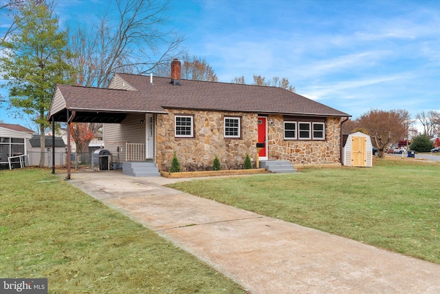 view of front facade with a front yard and a storage shed