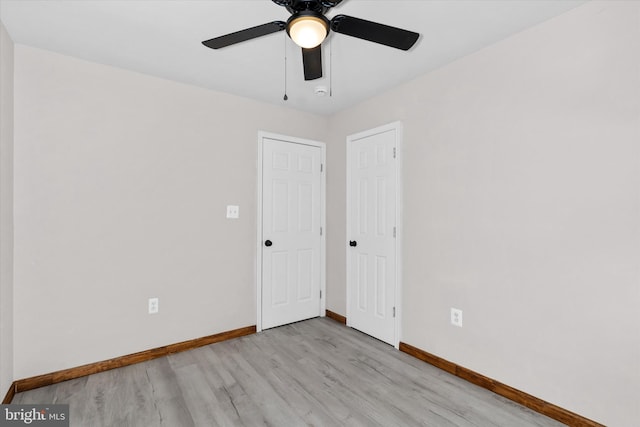 spare room featuring ceiling fan and light hardwood / wood-style floors