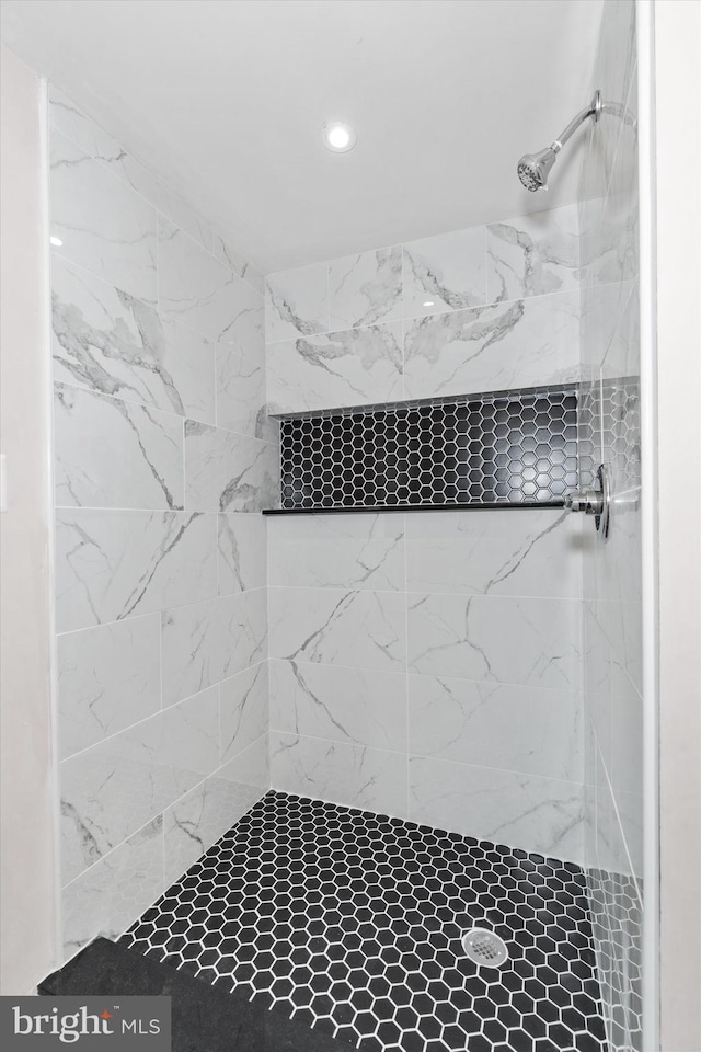 bathroom with tiled shower