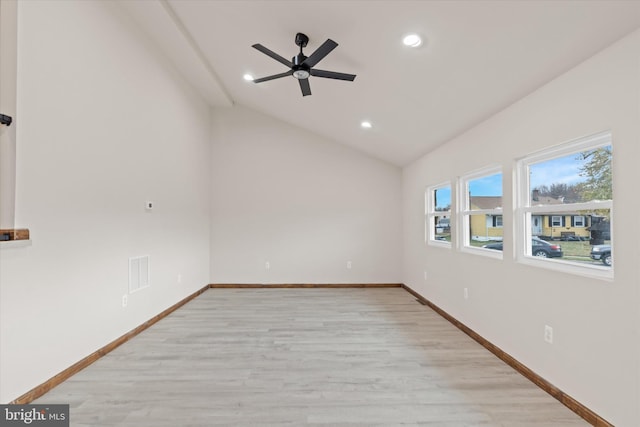 unfurnished room featuring ceiling fan, vaulted ceiling, and light wood-type flooring