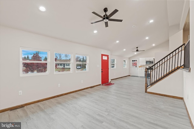 interior space featuring ceiling fan, light hardwood / wood-style floors, and vaulted ceiling