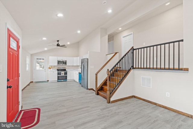 entryway featuring light hardwood / wood-style floors, ceiling fan, and lofted ceiling