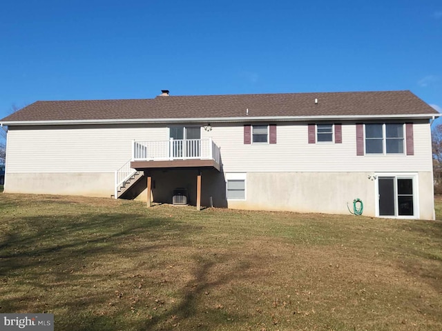 back of property with a lawn, cooling unit, and a wooden deck