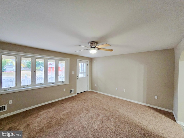 empty room featuring ceiling fan and carpet floors