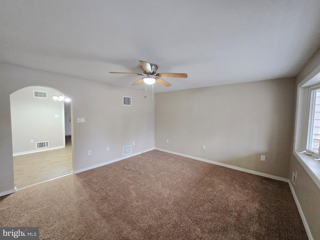 carpeted empty room featuring ceiling fan