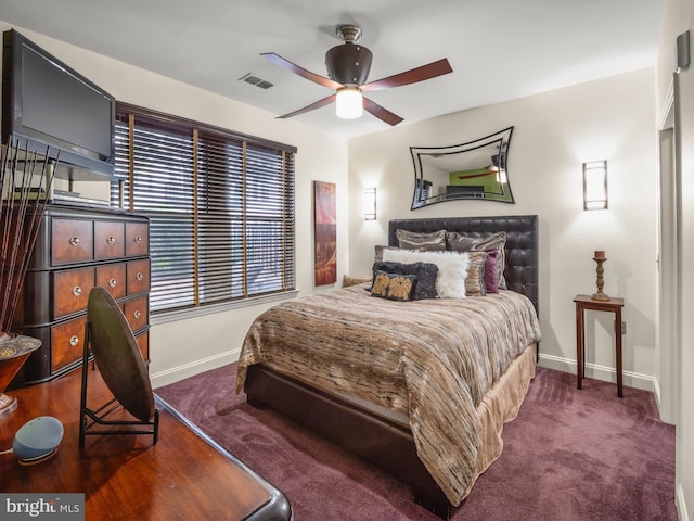 bedroom featuring ceiling fan and dark carpet