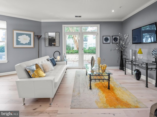 living room with light hardwood / wood-style floors and ornamental molding