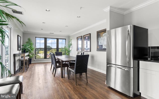 dining space featuring dark hardwood / wood-style flooring and ornamental molding