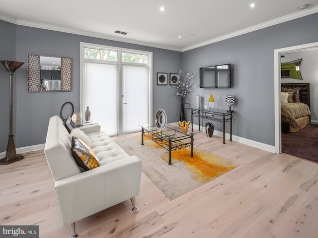 living room featuring crown molding and light hardwood / wood-style floors