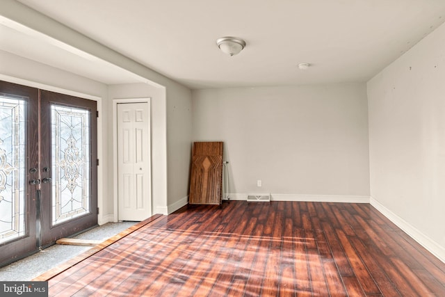 entryway with a wealth of natural light, french doors, and dark hardwood / wood-style floors