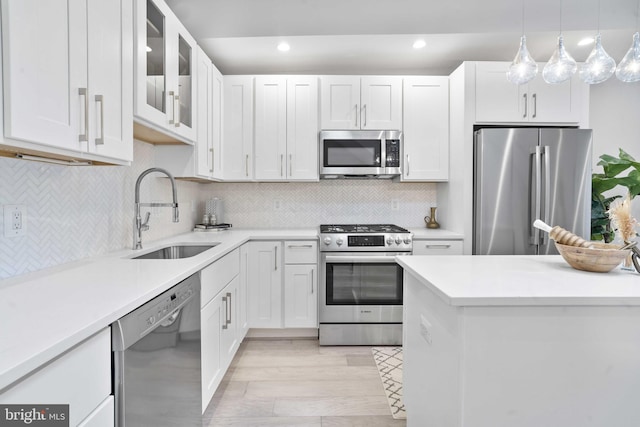 kitchen featuring white cabinetry, sink, and stainless steel appliances