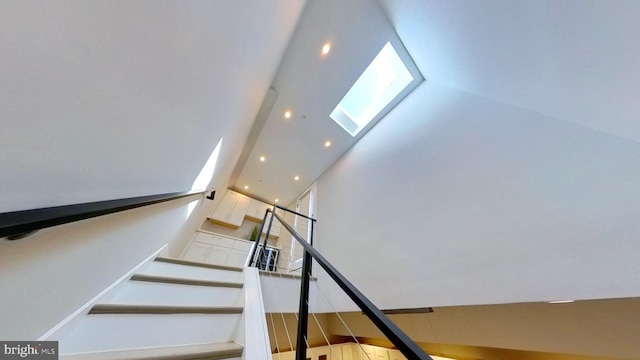 staircase with a towering ceiling